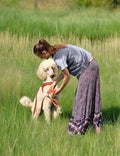 a girl and a standard poodle in a sunny park