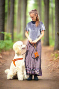  a girl and her standard poodle in a sunny park