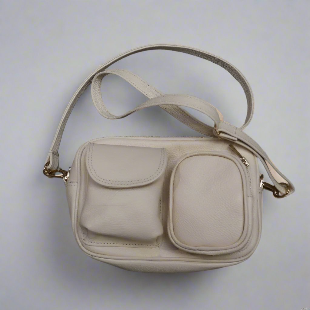 beige leather dogmom bag,with shoulder strap. one big compartiment with zipper, one small with zipper and hole for poopbags, one small with magnetic closure for treats