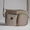 beige leather dogmom bag,with shoulder strap. one big compartiment with zipper, one small with zipper and hole for poopbags, one small with magnetic closure for treats