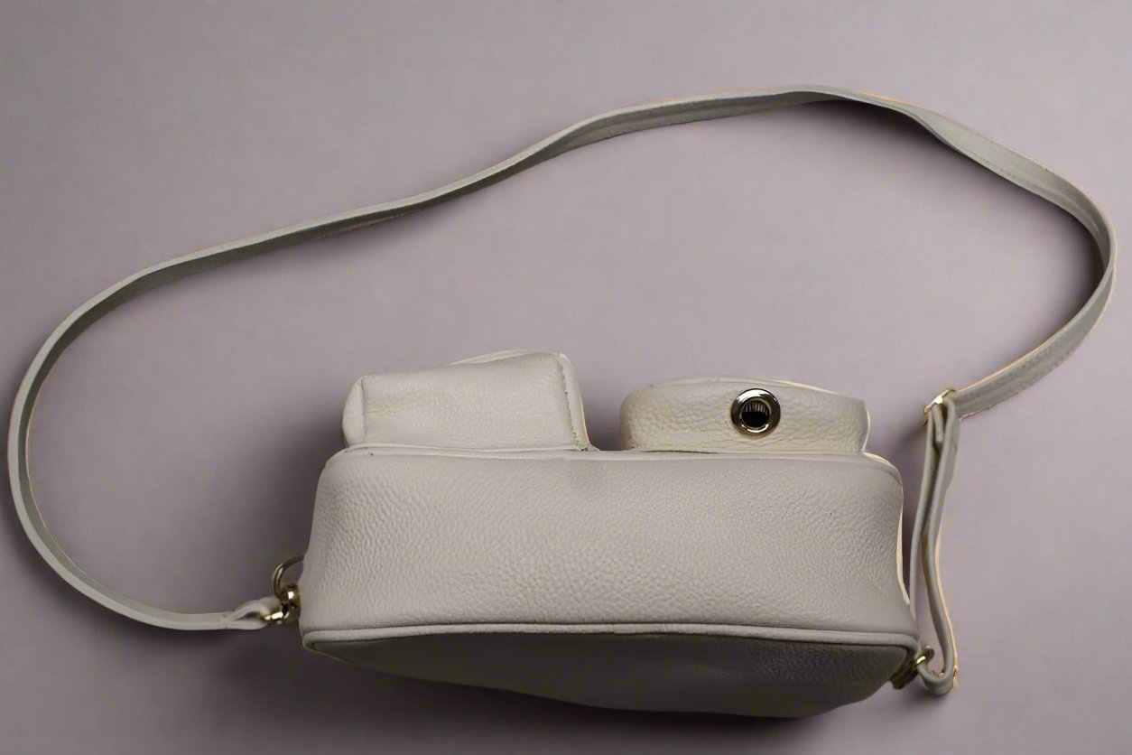 beige leather dogmom bag,with shoulder strap. one big compartiment with zipper, one small with zipper and hole for poopbags, one small with magnetic closure for treats