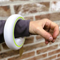 a hand with a handsfree rollable leash in white