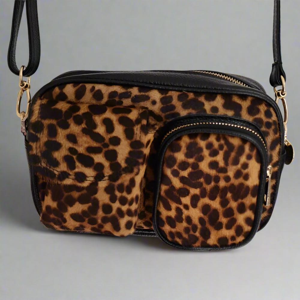 leopard leather dogmom bag, black lambs leather with leopard pony. With shoulder strap. One big compartment with zipper, one small compartment with zipper and hole for poopbags, one small compartment for treats, closes with magnet