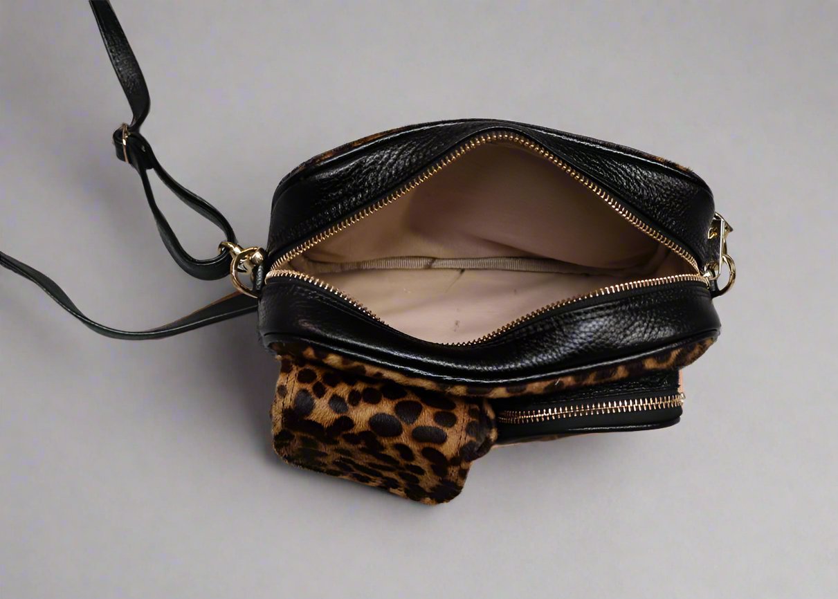 leopard leather dogmom bag, black lambs leather with leopard pony. With shoulder strap. One big compartment with zipper, one small compartment with zipper and hole for poopbags, one small compartment for treats, closes with magnet