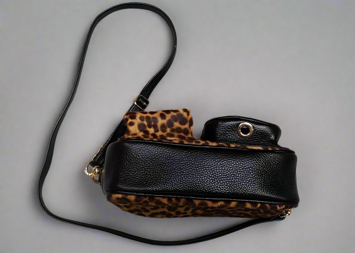 leopard leather dogmom bag, black lambs leather with leopard pony. With shoulder strap. One big compartment with zipper, one small compartment with zipper and hole for poopbags, one small compartment for treats, closes with magnet